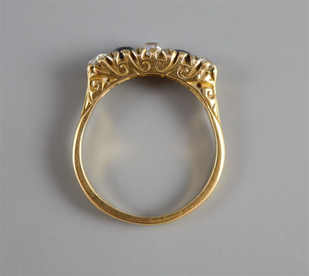 An early/mid 20th century 18ct gold and platinum, two stone sapphire and three stone diamond half hoop ring,